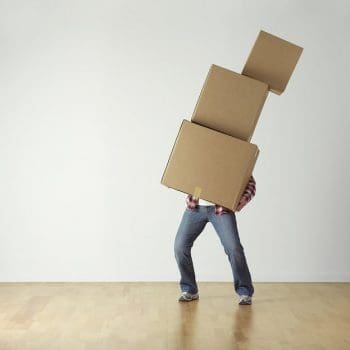 Man struggling to move boxes