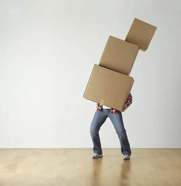 Man struggling to move boxes