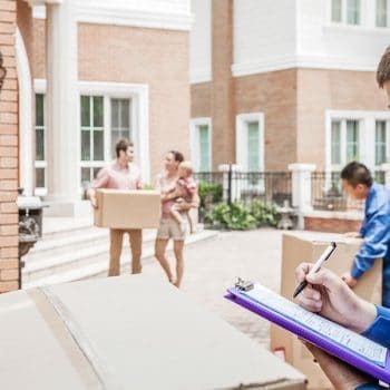 Moving company carrying boxes and invoice