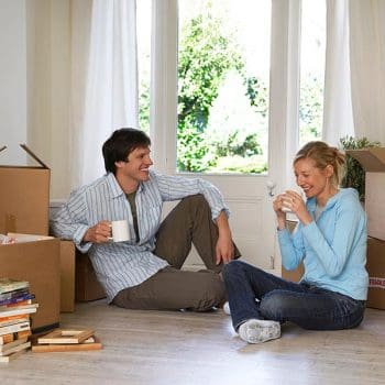 Happy couple taking a break during a move