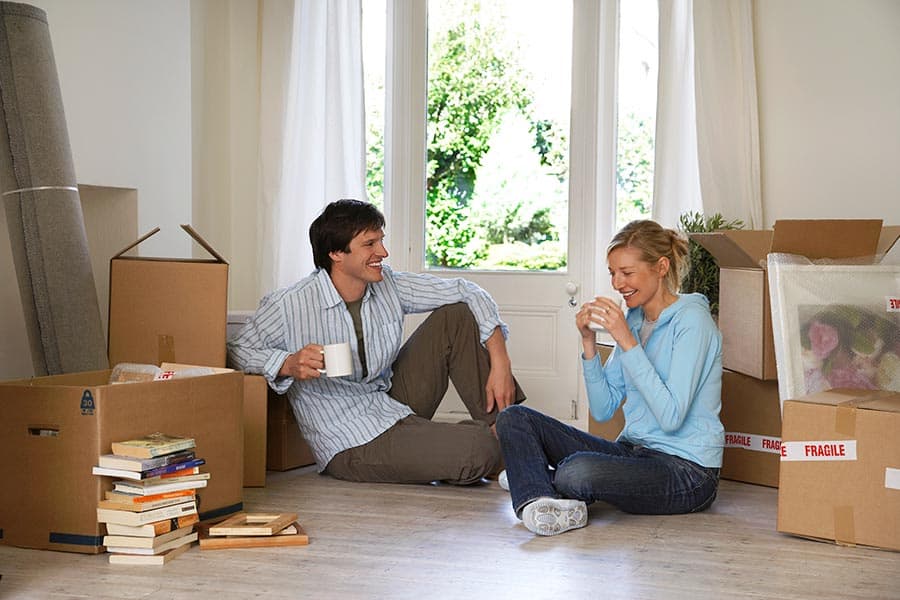 Happy couple taking a break during a move
