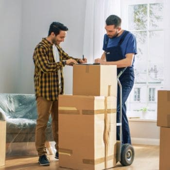 A customer happily signing for a commercial moving company in DFW
