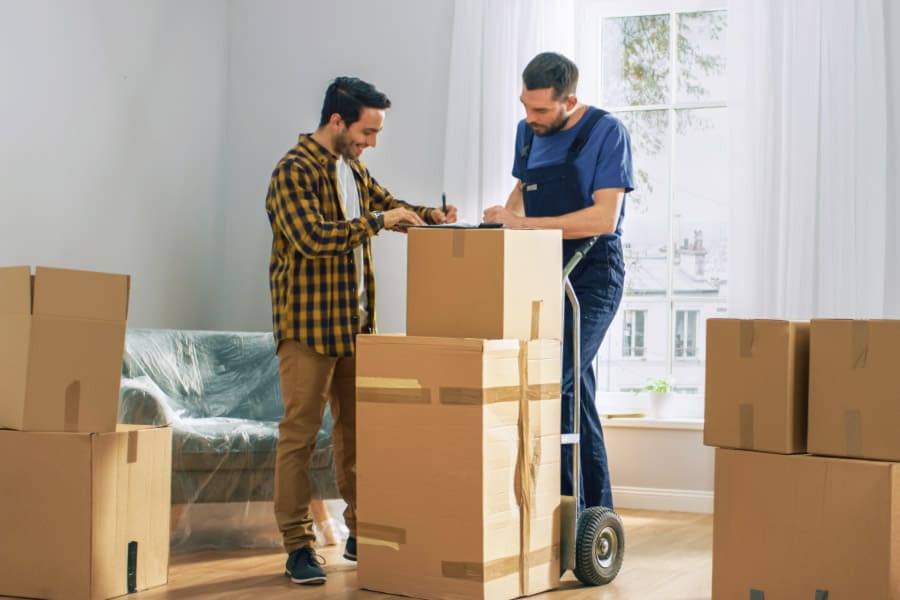 Man happily signing for a moving company