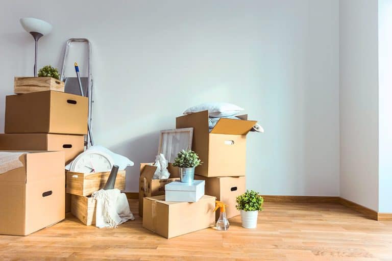 Moving boxes overflowing with too many household objects