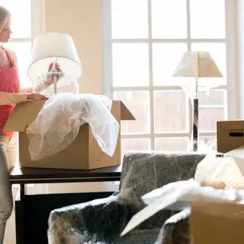Woman wrapping her items in bubblewrap