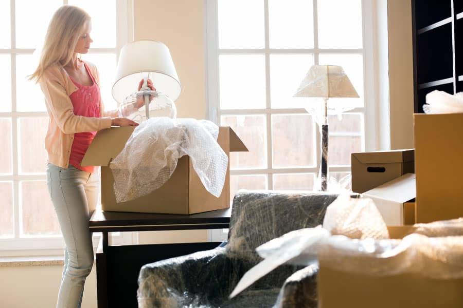 Woman wrapping her items in bubblewrap