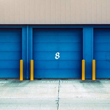 A row of numbered storage units with blue doors