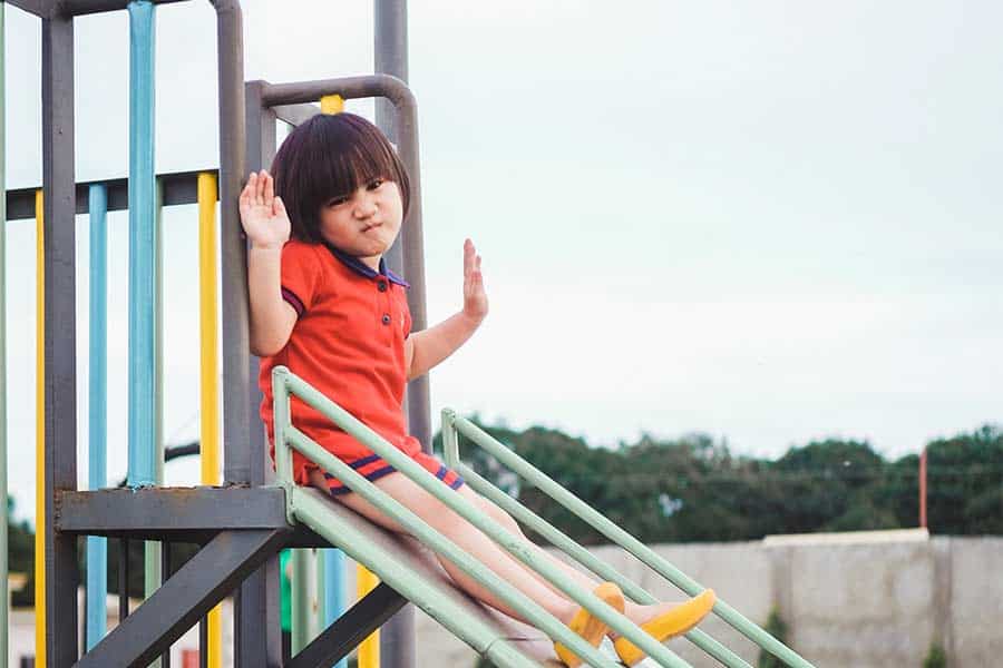 Child sliding on a backyard play set