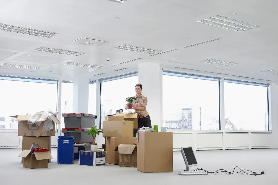 A woman packing the office for a corporate relocation to Dallas.