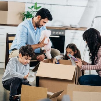 A happy family unpacking their belongings in their new home.