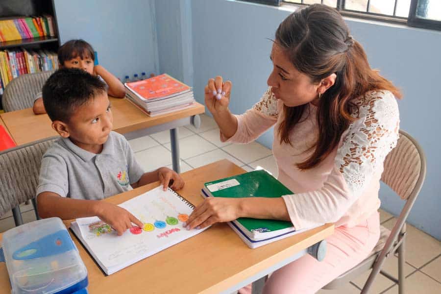 Elementary school teacher working with a student