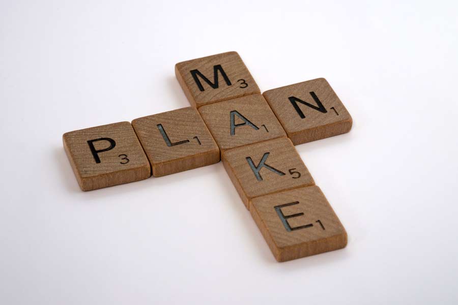 Wooden blocks spelling "MAKE" and "PLAN"