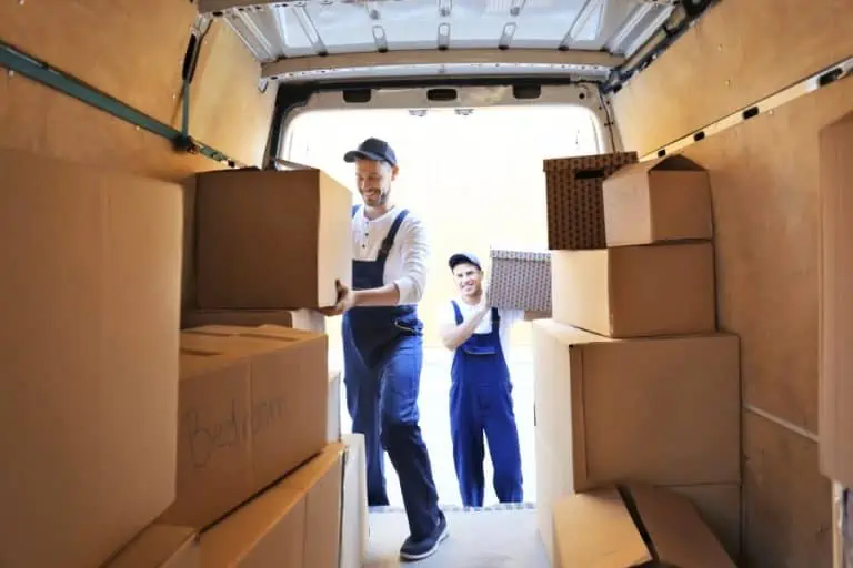 movers loading boxes into a moving van