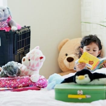 Child Packing up her favorite Stuffed Animals