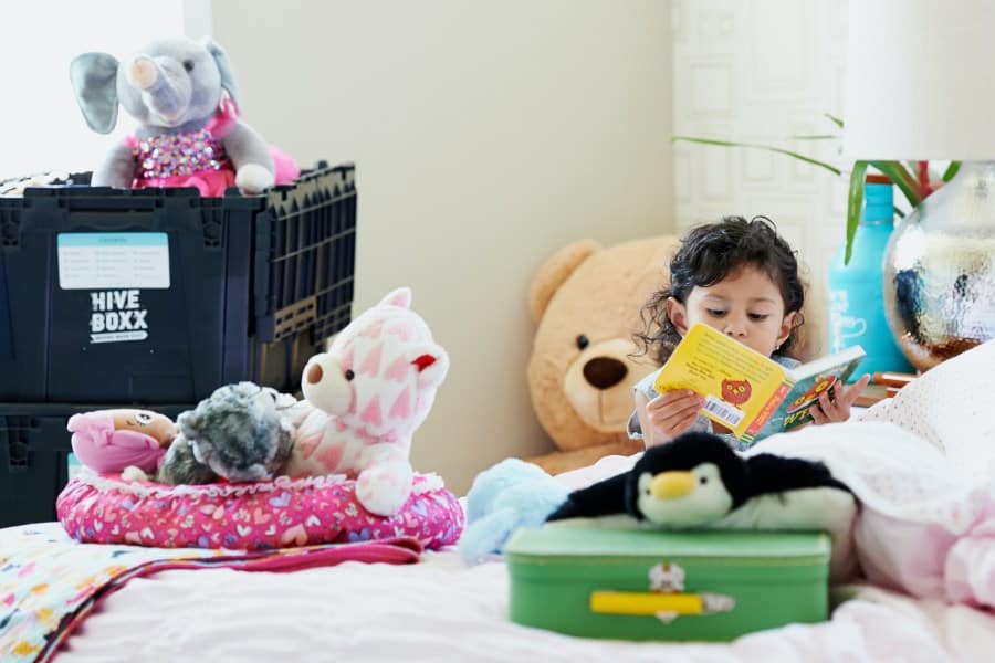 Child Packing up her favorite Stuffed Animals