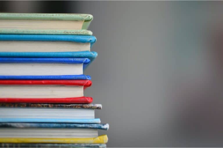 A Stack of colorfully bound books close up
