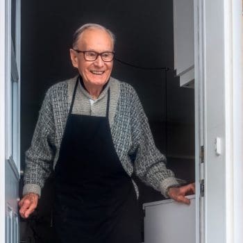 Happy elderly man getting ready to move out