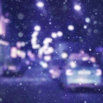 blurred picture taken from windshield of driving moving truck during snow