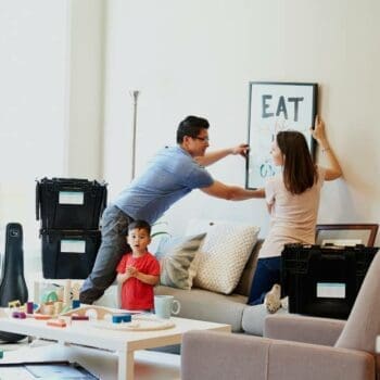 Photo of family packing for home move using plastic bins