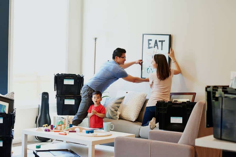 Photo of family packing for home move using plastic bins